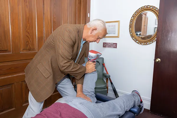 Chiropractor Mobile AL Donald Ellis Adjusting Lower Leg Patient Chiropractor Mobile AL Donald Ellis Adjusting Lower Leg Patient