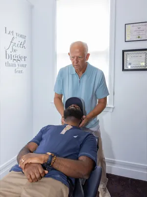 Chiropractor Mobile AL Donald Ellis Adjusting Arm Pain Patient Chiropractor Mobile AL Donald Ellis Adjusting Arm Pain Patient